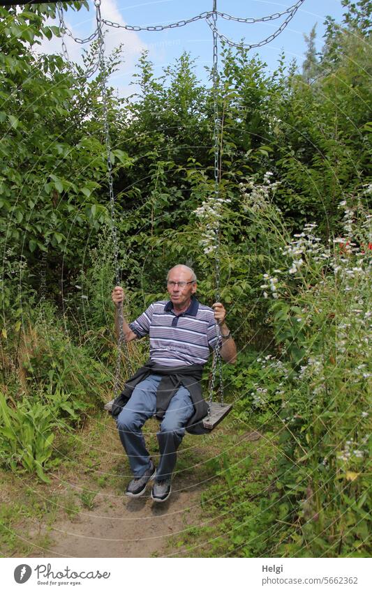 the child in the man ... :-) Human being Man Senior citizen Swing To swing Garden plants flowers blossoms Nature Exterior shot Joy Summer