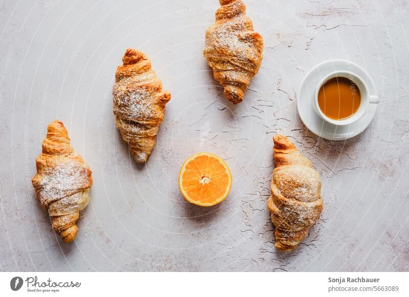 A cup of coffee and fresh croissants on a gray rustic table. Top view. Coffee Cup Croissant Breakfast Table Rustic Beverage Caffeine Morning Drinking Dessert