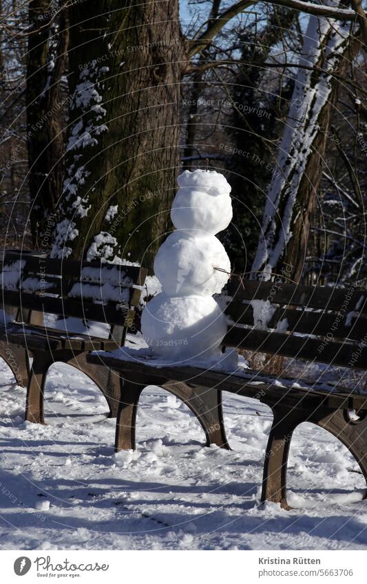 a snowman takes a break Snowman Bench Wooden bench Park bench Winter Break Sit tired sluggish wittily Funny creatively snow sculpture Snow figure Season out