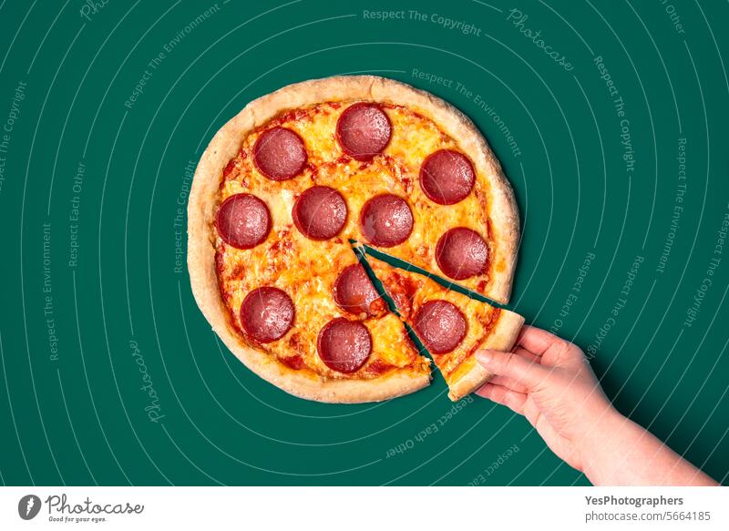 Homemade pizza salami isolated on a green background above baked bright chart cheese color colorful comfort crust cuisine delicious delivery design dinner dish