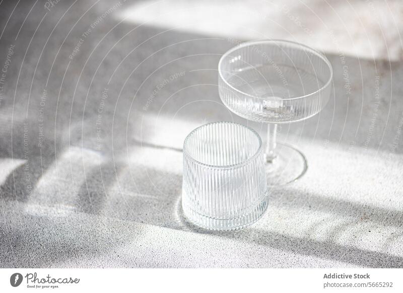Elegant Glassware in Soft Sunlight and Shadows glassware sunlight shadow texture elegant soft play surface piece textured table decor home interior still life