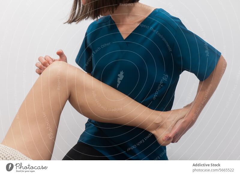 Close-up of a person grasping their ankle in discomfort pain medical wear injury blue holding close-up health leg foot adult human body body part physical pain