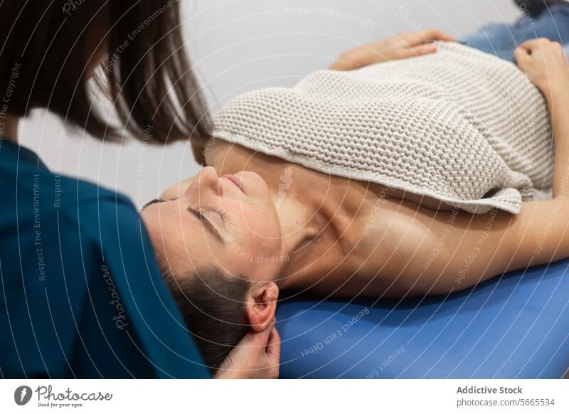 Relaxing neck massage at wellness center woman therapist relaxation tranquil setting professional therapy health treatment spa lying down practitioner hands