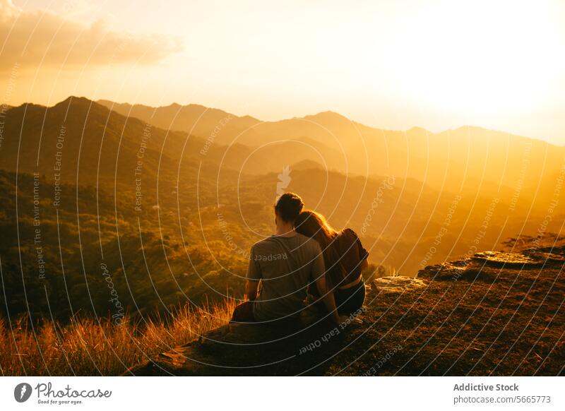Couple embracing while watching a mountain sunset in Minca, Colombia couple embrace serene landscape love togetherness nature hill dusk evening outdoors romance