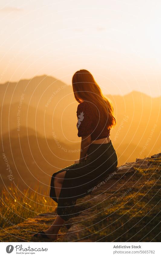 Contemplative woman enjoying a serene mountain sunset in Minca, Colombia solitude serenity contemplation nature golden hour sitting silhouette warm light dusk