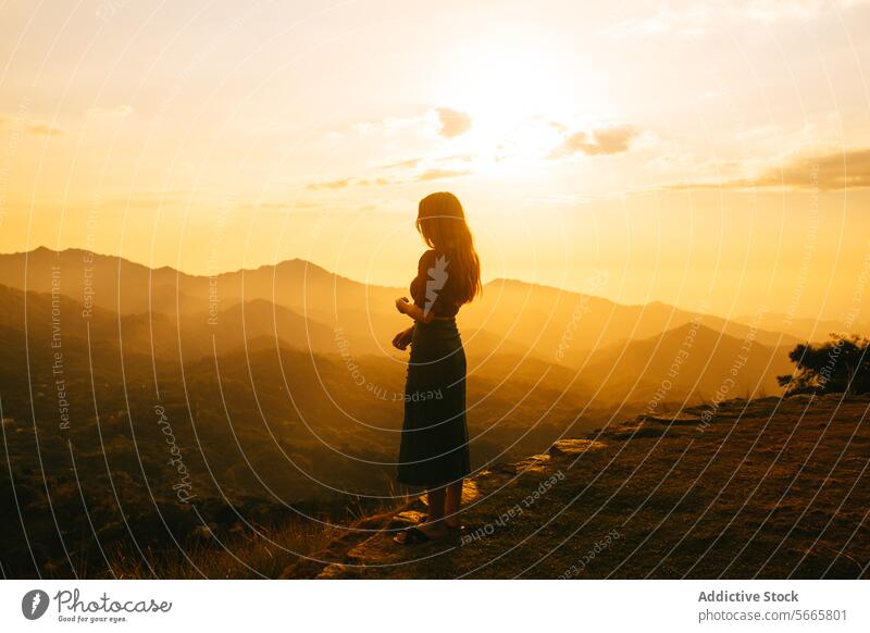 Contemplative Woman Gazing at Sunset in Mountains in Minca, Colombia woman sunset mountain contemplation solitude nature scenic view landscape glow warm dusk