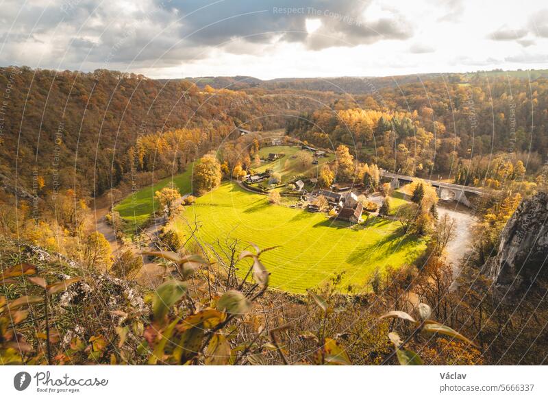 Rocky environment near the town of Dinant with a watercourse that forms natural meanders in autumn colour. The sunset illuminates a colourful forest curve