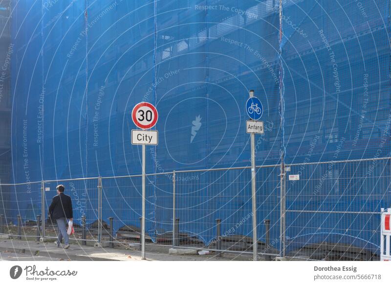 Large construction site cordoned off Construction site large construction site Building veiled facade Renovation Blue safety net Hoarding Town urban Safety