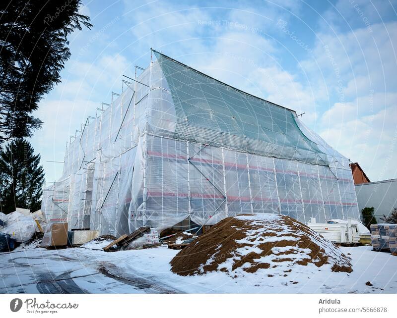 Wrapped house on a construction site in winter Construction site House (Residential Structure) Scaffold Tarp construction net construction foil Net Renovation