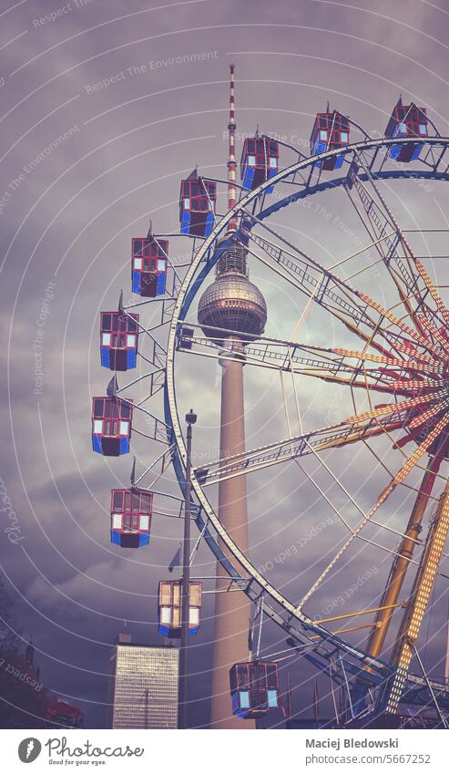 Color toned photo of the Ferris wheel in Berlin at dusk, Germany. berlin ferris wheel city ride dark retro vintage tower fun germany blue sky cityscape travel