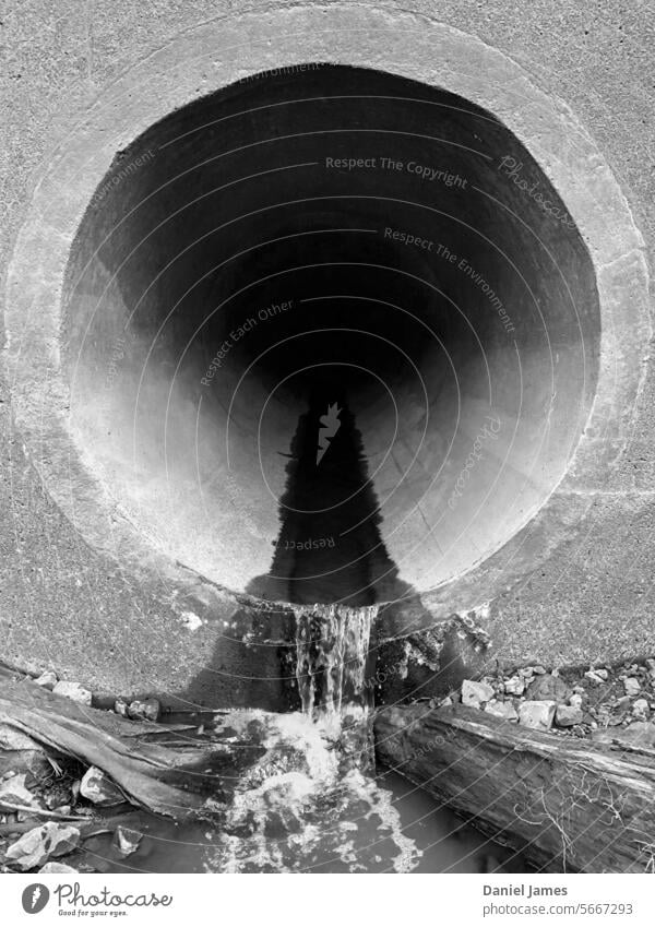 Large drain with a small flow of water. Drainage Drainpipe Drainage system Pipe Concrete Water waste Waste management waste water Hellmouth Black & white photo