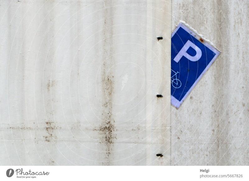 bicycle parking Wall (building) sign Parking lot Bicycle lot Corrugated iron wall Corrugated sheet iron jammed Deserted Exterior shot Facade Signs and labeling