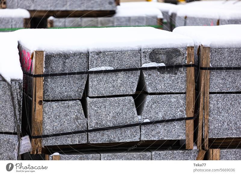 bricks on a construction site in winter snow ice construction work house hold break building seasonal
