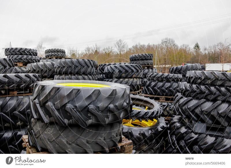 Used tractor wheels and tyres stacked on pallets Heavy Public Transportation Road safety grip large old traction traffic tyre tread used