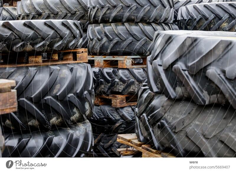 Used tractor wheels and tyres stacked on pallets Heavy Public Transportation Road safety grip large old traction traffic tyre tread used