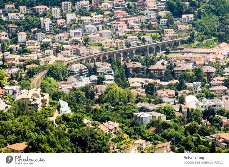 View of a district of Trieste Bridge Railway bridge Historic Town Italy Suburb Quarter Building houses trees Green Old track Red roofs vacation Nature