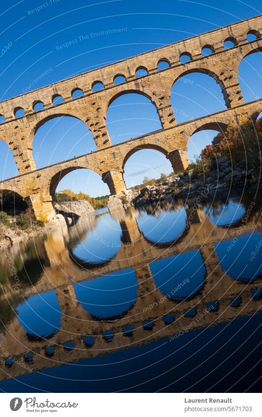 The Pont du Gard, vertical photography tilted over blue sky. Ancient Roman aqueduct bridge. Photography taken in Provence, southern France ancient arch