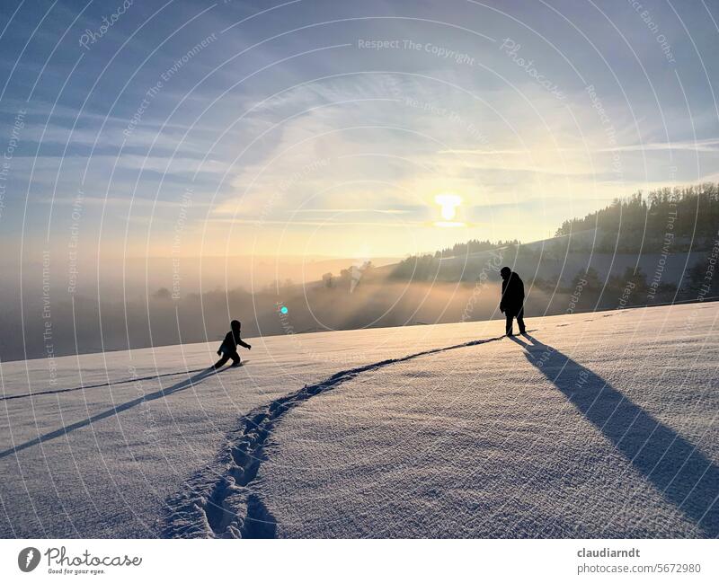 A child and an adult in the snow, at sunset and backlit. The child approaches the adult. Snow Snowscape Winter Sunlight Back-light Sunset Child more adult ways