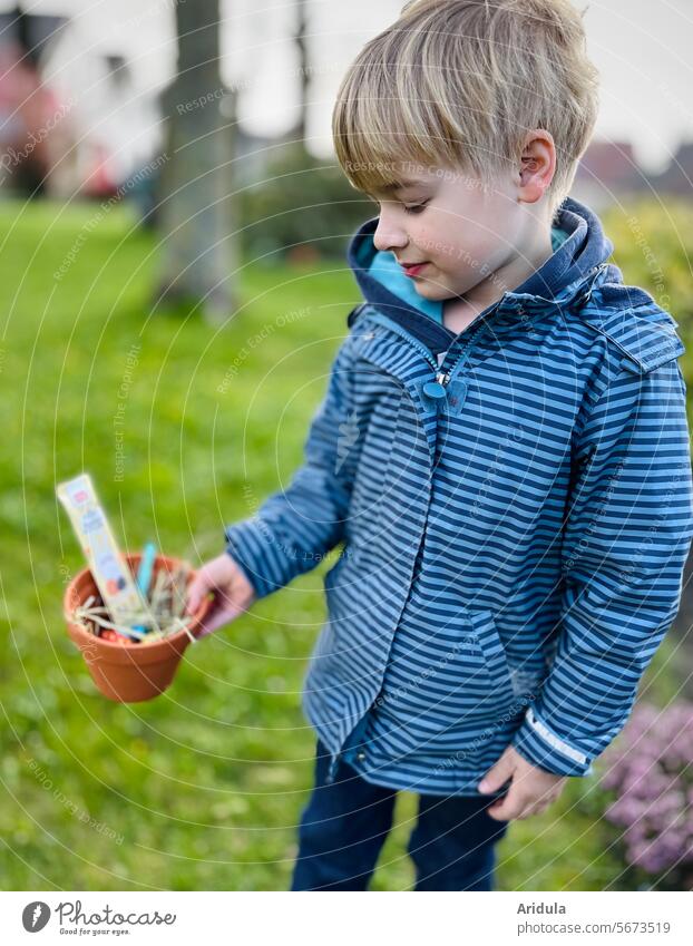 Easter | Child holds a clay pot in his hand in which an Easter nest is hidden Easter egg hunt Nest Easter egg nest Spring Tradition Feasts & Celebrations Garden