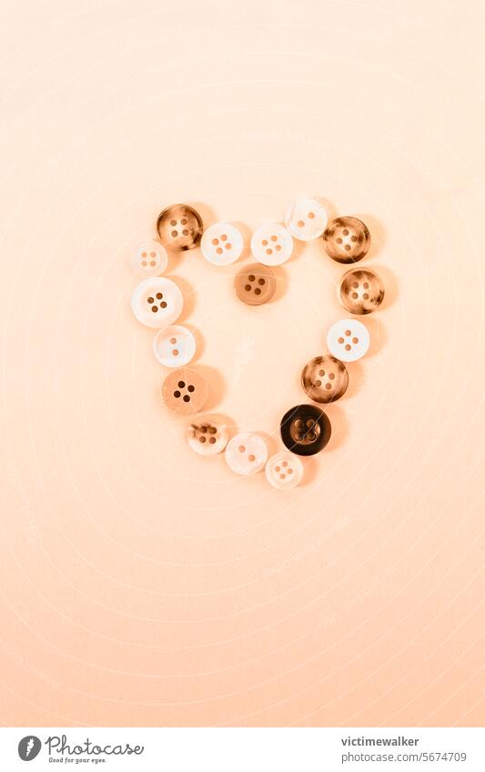 Buttons forming heart shape love background buttons peach color symbol valentine card romantic studio shot romance monochrome honeymoon falling in love wedding