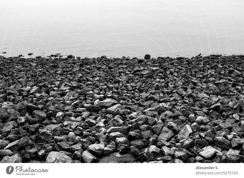 Stone beach on the shore Pebble beach bank Shore line Water Ocean stones gravel graphically Intersection coast Beach Landscape coastline Sea coast Seashore