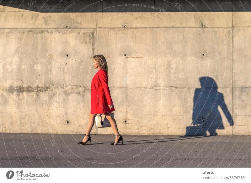 Side view of a business woman walking by the city red outdoors adult sideview female success building lifestyle professional office urban adults only manager