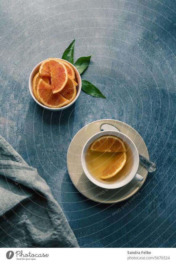 Orange tea in a teacup with a bowl of oranges Tea Beverage Healthy layflat Tea cup Drinking Cup Table