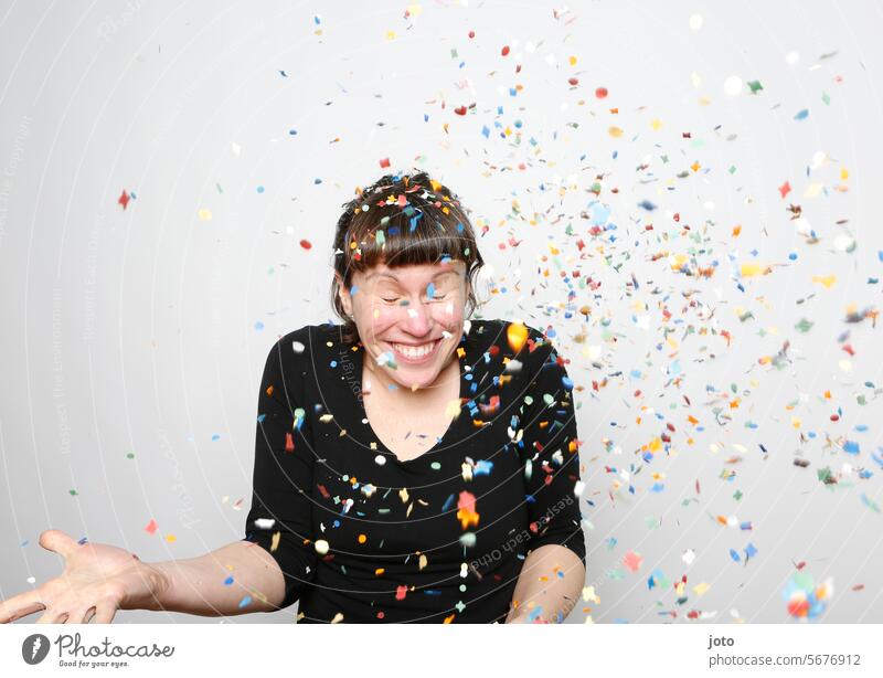 Woman laughingly throws colorful confetti into the air Confetti showery with confetti variegated Party Party mood Party goer Feasts & Celebrations Birthday