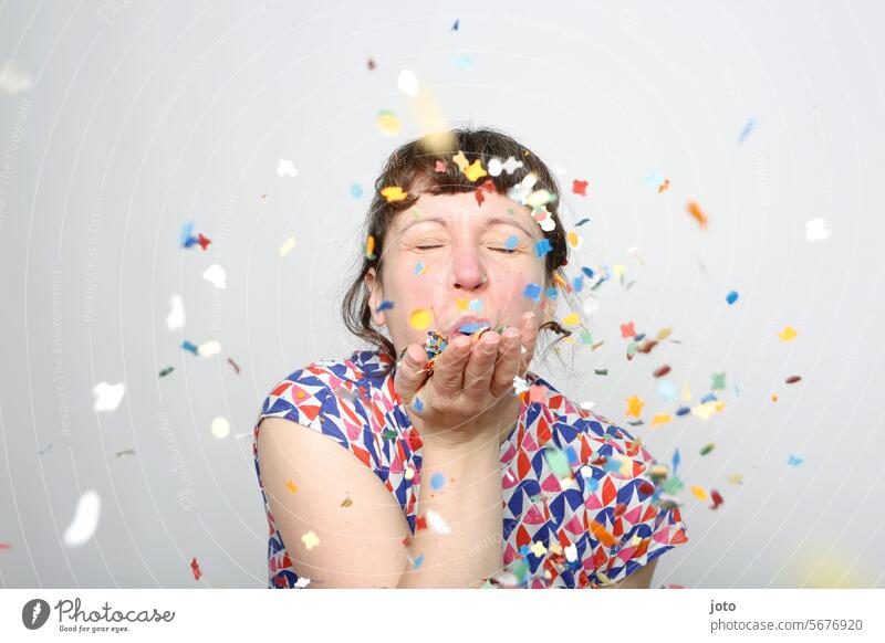 Woman blows colorful confetti into the air Confetti showery with confetti variegated Party Party mood Party goer Feasts & Celebrations Birthday fortunate