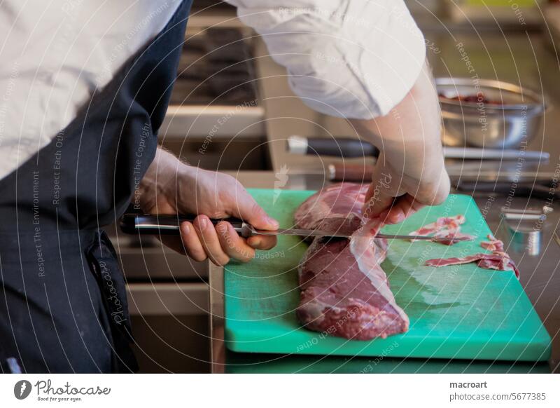 Meat is cut in a kitchen and the fat is removed Kitchen star chef sirloin filleted Preparation boil Eating food Nutrition chef de cuisine Knives tart Close-up