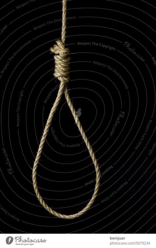 knotted gallows rope on a black background Gallows rope Suicide Rope Penalty noose Stress Execution Death symbol String Neck Lasso Executioner Force Bow concept