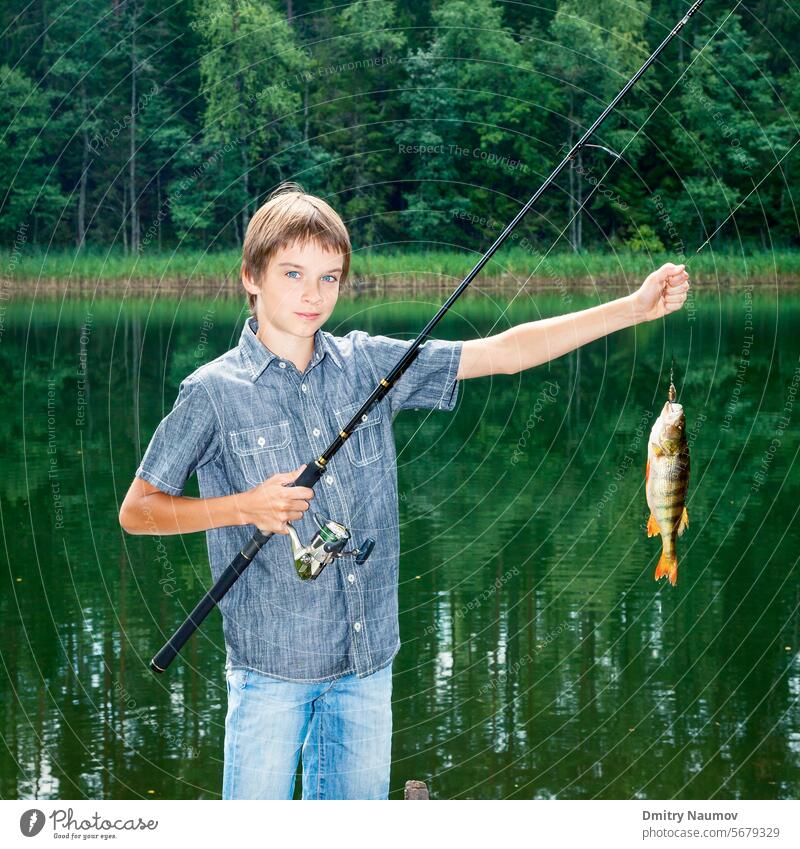 Boy showing fish he caught while fishing Instagram achievement activity angler angling boy catch caucasian child childhood cute fisher fisherman freshwater