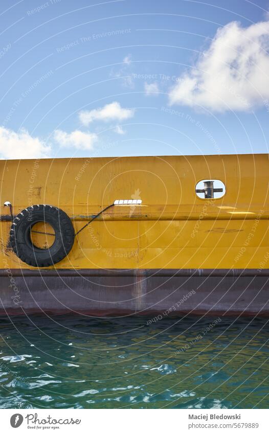 Close up picture of the side of the ship. boat port starboard vessel sea moored industry water outdoor transportation ocean nautical maritime side view