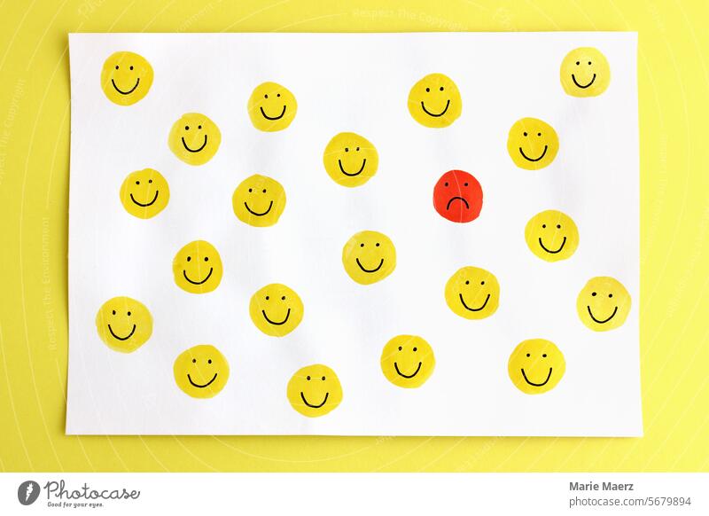 A lonely unhappy emoticon among many happy smiling smileys Smiley face sad on one's own Loneliness Lonely fortunate Yellow Many group Emotions Moody