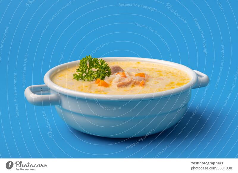 Chicken soup bowl close-up, isolated on a blue background avgolemono bright carrots chicken citrus color creamy cuisine delicious dinner dish egg enamel