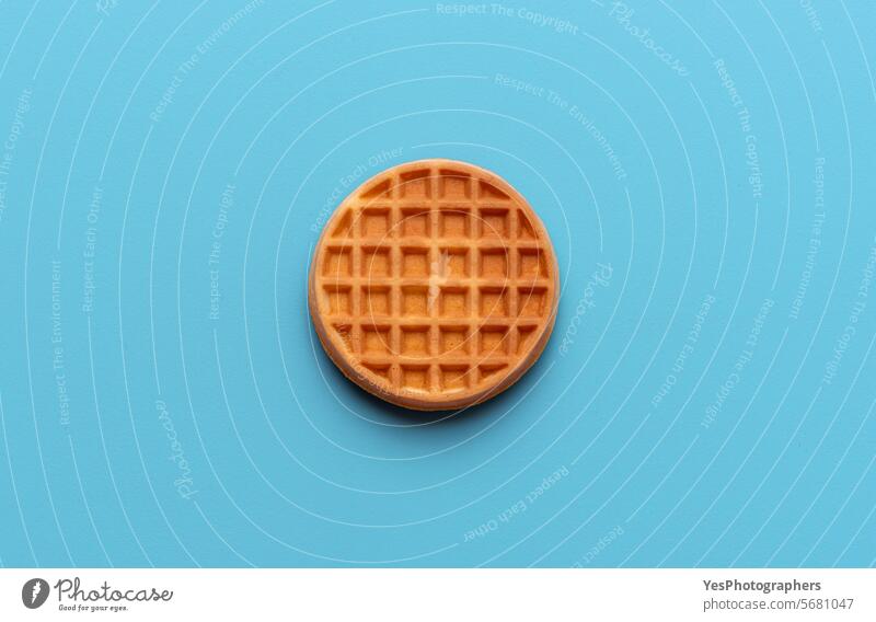 Round waffle directly above view, isolated on a blue background baked baking belgian biscuit breakfast bright circle color colorful cuisine delicious dessert