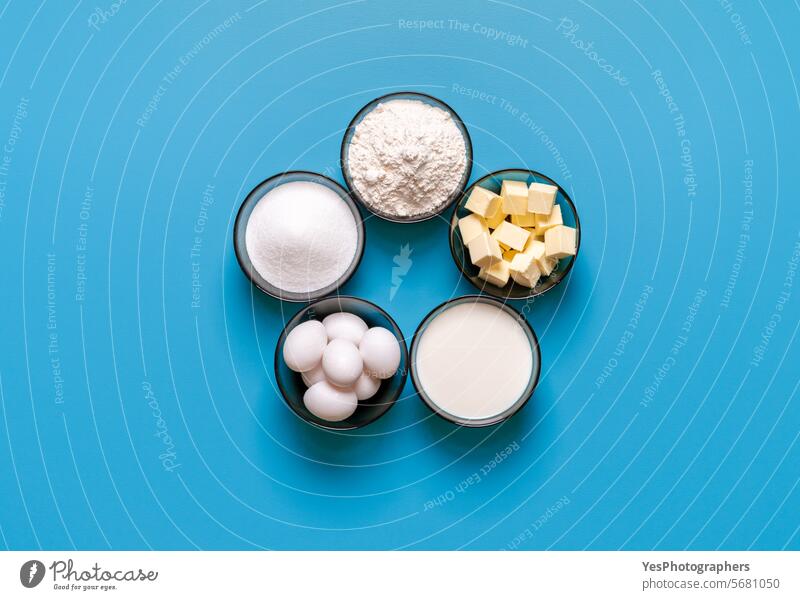 Waffle ingredients top view, isolated on a blue background above baked baking biscuit bowl breakfast bright butter cake calories color colorful cooking