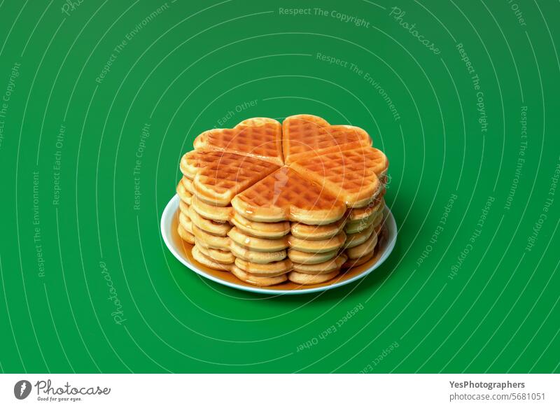 Waffles with mapple syrup on a plate, isolated on a green background above baked baking bathed belgian biscuit breakfast bright cake calories color colorful