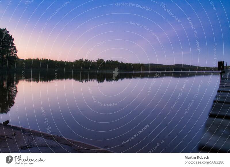 Sunset on a lake in Sweden. Blue hour on calm water. Nature photo from Scandinavia Lake reflection sunset smalland travel lightness nature forest vacation