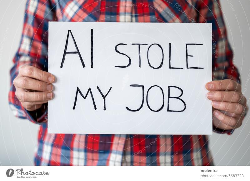 Anonymous person holding sign with inscription "AI stole my job" artificial intelligence ai work loss technology unemployment progress changes globalization