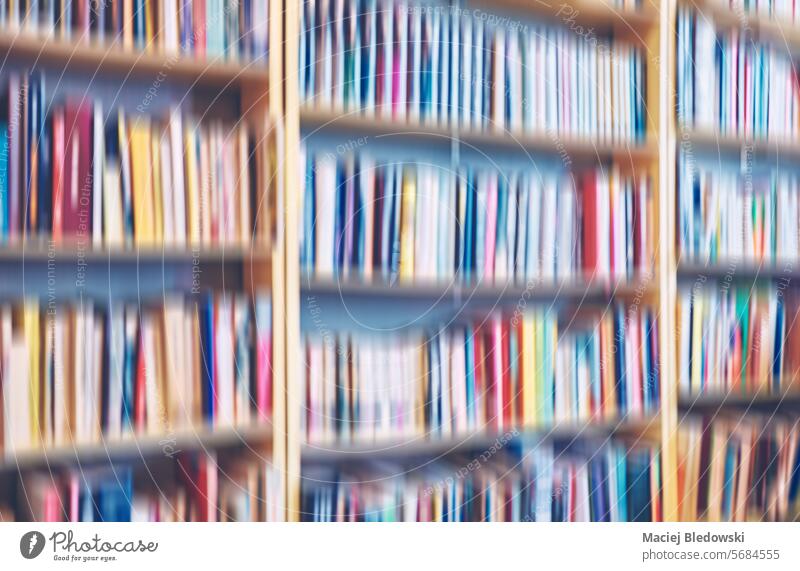 Motion blurred rows of books, abstract background. bookstore education motion blur bookshelf library wallpaper toned collection pattern colorful de focused