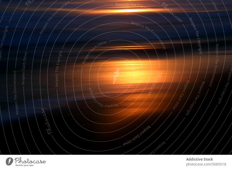 Abstract sunset glimmer on ocean waves abstract reflection warm glow seascape serene blurred tranquil natural light dusk evening shoreline gold orange motion