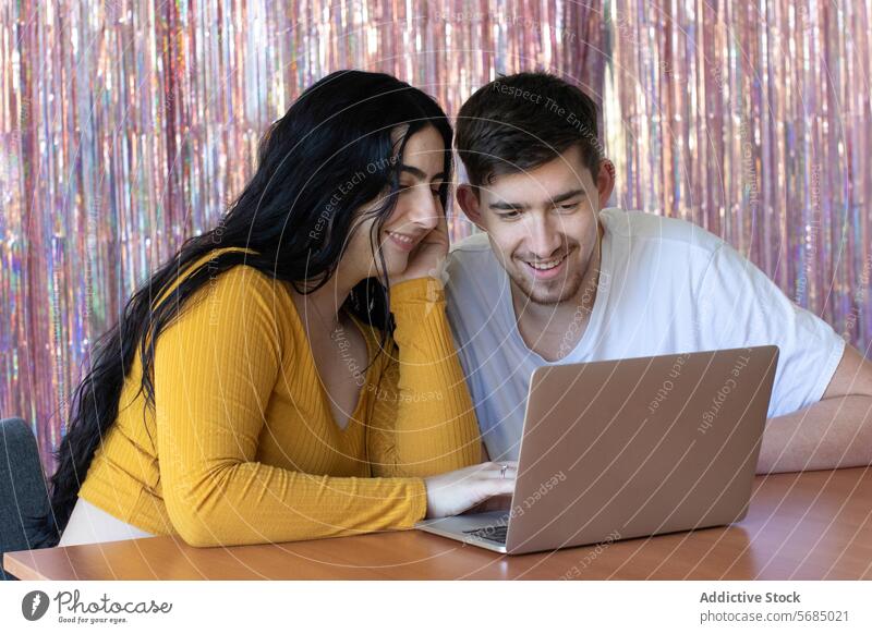 Smiling couple using gadgets while spending time together laptop happy beard man woman smile toothy smile delight pastime electronic husband partner lover