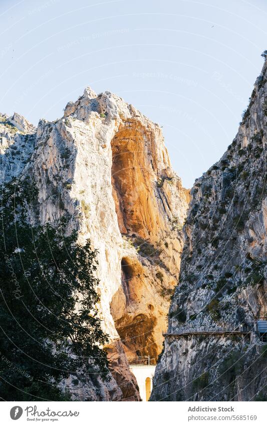 Sunlit peak of a massive rock formation with the Caminito del Rey path along the side in Malaga sunlit cliff Torcal Antequera mountain nature landscape scenic