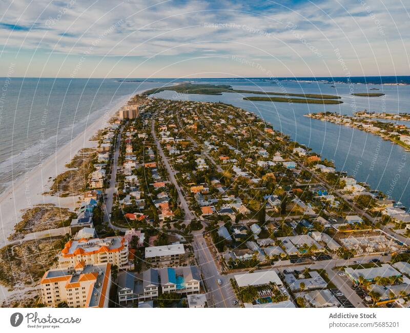 Aerial view of a coastal neighborhood in Miami, Florida miami florida aerial view waterfront properties beach sandy streets residential area buildings houses