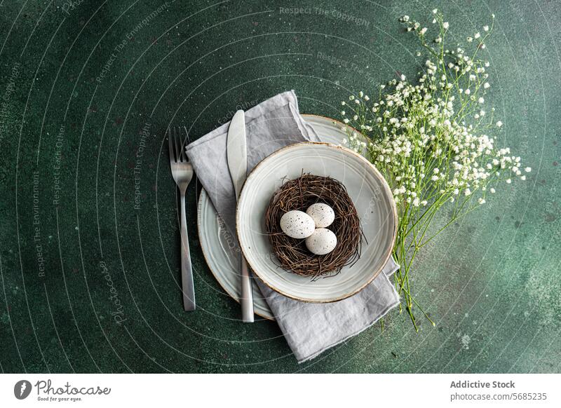 Elegant spring table setting with nest and eggs speckled crockery bouquet baby's breath elegant artistic layered fork knife linen napkin plate centerpiece