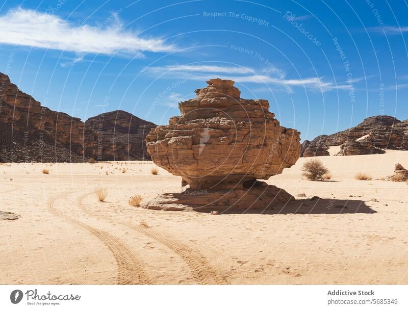 Majestic rock formation in the Tadrart Rouge desert tadrart rouge landscape blue sky clear solitary vast nature geology arid sand terrain scenic beauty algeria