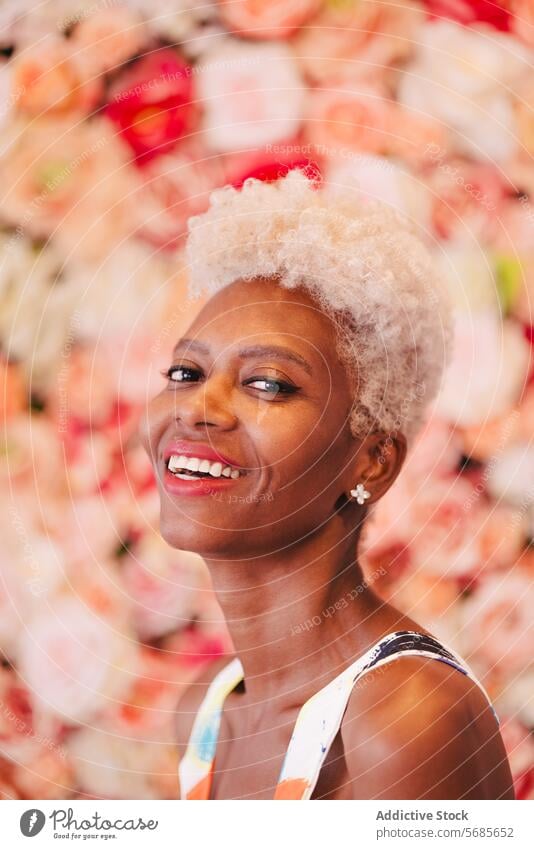 Smiling black woman near pink blooming flowers summer bouquet happy smile cheerful floral blossom positive charming enjoy style colorful tender celebrate barbie