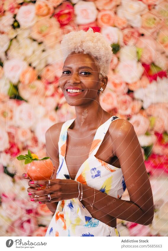Cheerful black woman with cocktail flower cheerful happy smile bouquet summer positive enjoy young laugh glad floral style spring celebrate fresh pleasure