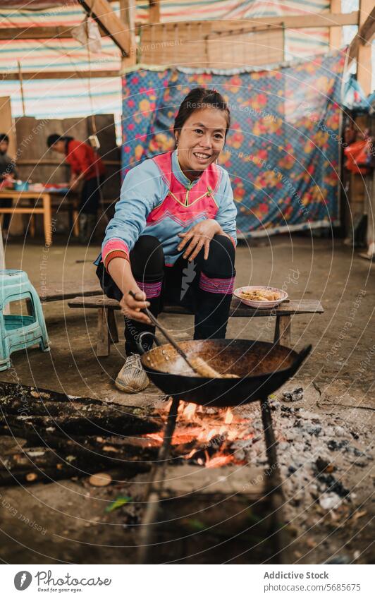 Asian woman preparing food in kitchen with frying pan prepare wok lady sit cook tongs bench shabby utensil female culinary cuisine household tradition vietnam